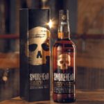 Smokehead capitalises on barbecue season with new campaign A bottle and outer box of Smokehead whisky stand on a table.