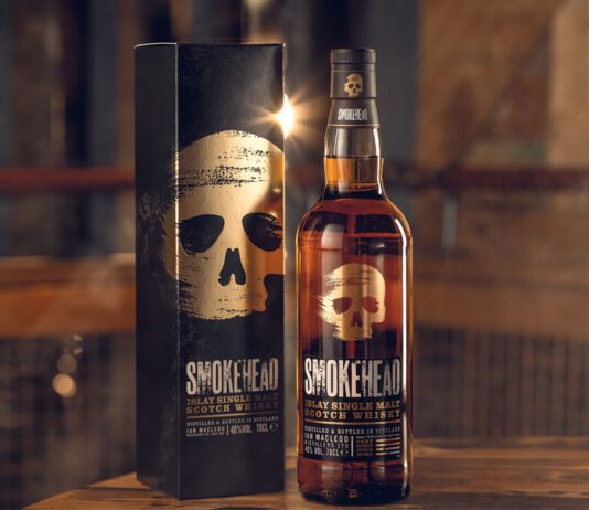 Smokehead capitalises on barbecue season with new campaign A bottle and outer box of Smokehead whisky stand on a table.