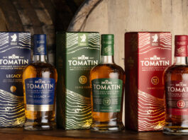 Tomatin showcases striking new packaging Bottles of Tomatin featuring the 2026 redesign with whisky casks behind the bottles.