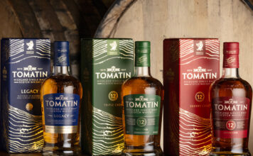 Tomatin showcases striking new packaging Bottles of Tomatin featuring the 2026 redesign with whisky casks behind the bottles.