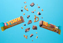 Yorkie unveils new Salted Caramel Pretzel bar A Yorkie Salted Caramel Pretzel bar is broken in two with pieces flying out from it against a blue background.