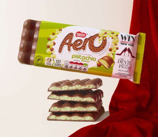 Aero takes to the runway with new Pistachio flavour A pack of Aero Pistachio is balanced on top of bars of the chocolate with a red fabric draped behind it.