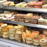 Food inflation forecasts climb upwards Bakery cabinet with cakes and pastries.