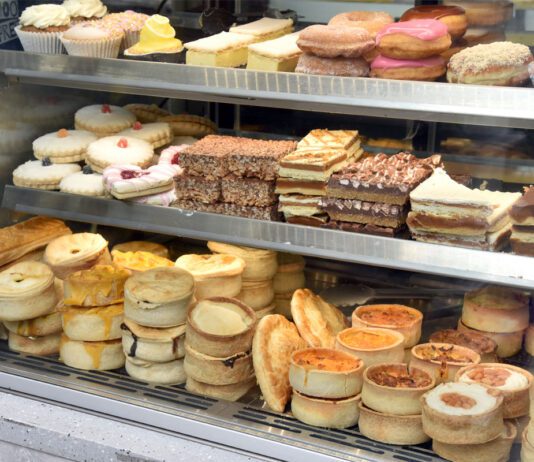 Food inflation forecasts climb upwards Bakery cabinet with cakes and pastries.