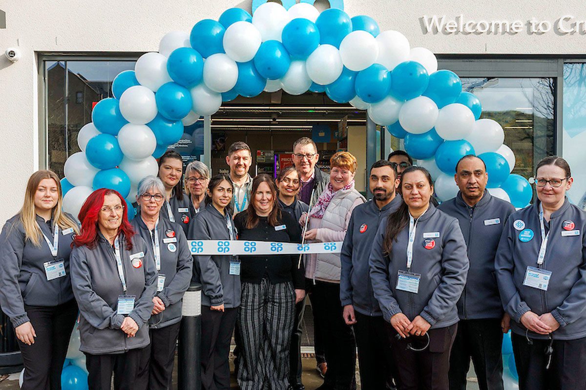 A group of people stand outside for the opening of Co-op Cruden Bay.