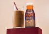 Costa Coffee introduces new Jaffa Cakes Frappé A bottle of Costa Coffee Frappé Jaffa Cakes stands next to a glass with the drink inside.