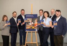 Politicians urged to support food and drink ahead of election A group of politicians stand around an easel with an advert for the Food & Drink Federation Scotland on it.