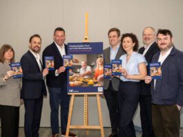 Politicians urged to support food and drink ahead of election A group of politicians stand around an easel with an advert for the Food & Drink Federation Scotland on it.