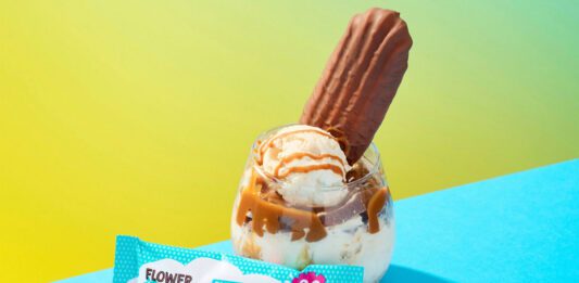 Finsbury acquires Flower & White snacks A glass with ice cream and a bar of Flower & White inside it stands behind a pack of Flower & White Salted Caramel Meringue Bar.