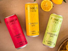 Funkin freshens up RTDs with new Spritz range Cans of Funkin Spritz are laid out across a table with sliced oranges above them and a bowl of crisps to the bottom right and olive to the top left.