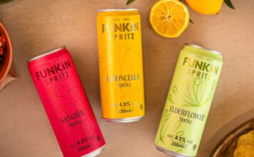 Funkin freshens up RTDs with new Spritz range Cans of Funkin Spritz are laid out across a table with sliced oranges above them and a bowl of crisps to the bottom right and olive to the top left.