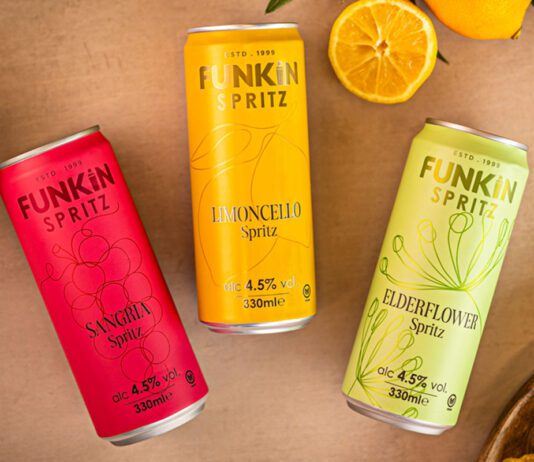 Funkin freshens up RTDs with new Spritz range Cans of Funkin Spritz are laid out across a table with sliced oranges above them and a bowl of crisps to the bottom right and olive to the top left.