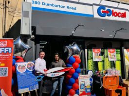 Glasgow’s first Go Local store opens its doors Two people stand outside Go Local Dumbarton Road holding a pair of novelty scissors at the store's door to mark the opening of the location.