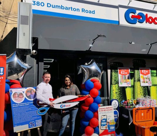 Glasgow’s first Go Local store opens its doors Two people stand outside Go Local Dumbarton Road holding a pair of novelty scissors at the store's door to mark the opening of the location.