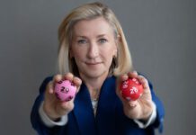 National Lottery set to launch two new games this summer Andria Vidler, chief executive at Allwyn UK, holds two lottery balls with a 20 and a 26 on them.