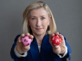 National Lottery set to launch two new games this summer Andria Vidler, chief executive at Allwyn UK, holds two lottery balls with a 20 and a 26 on them.