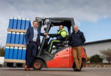 Mackie’s acquires new facility to grow distribution capacity L–R Stuart Common, MD at Mackie's, Roddy Adam, site supervisor, and Mac Mackie, chairperson, are gathered round a forklift truck that is carrying Mackie's ice cream containers.