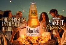 Modelo Especial launches across the UK Promotional image of the UK launch for Modelo Especial with people gathered round a campfire with a bottle of the beer rising out of the flames.