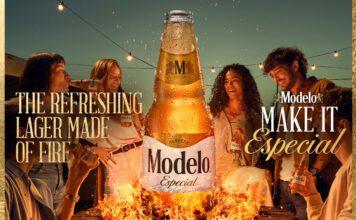 Modelo Especial launches across the UK Promotional image of the UK launch for Modelo Especial with people gathered round a campfire with a bottle of the beer rising out of the flames.