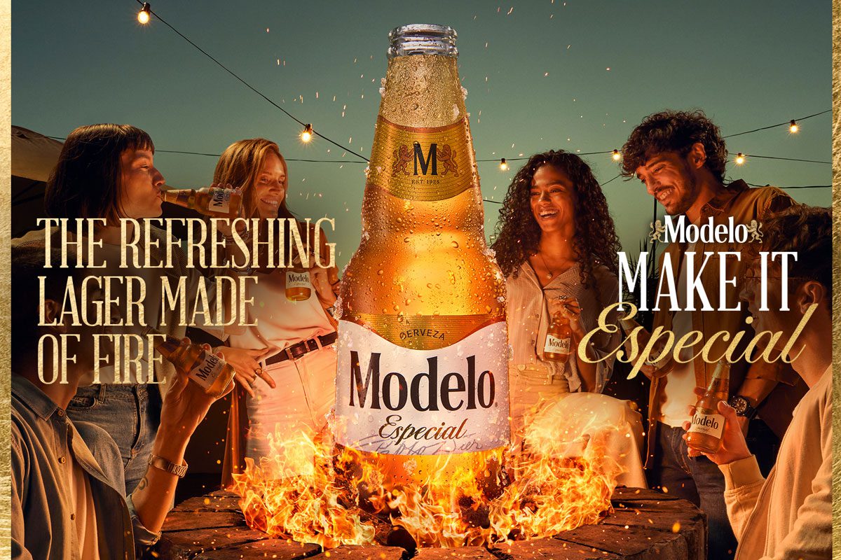 Promotional image of the UK launch for Modelo Especial with people gathered round a campfire with a bottle of the beer rising out of the flames.
