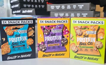 The Protein Ball Co rolls out new multipacks Packs of The Protein Ball Co Snack Packs stand upright on a table in Peanut Butter, Blueberry Oat Muffin and Salted Caramel flavours.