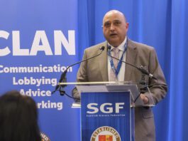 SGF highlights the true cost of wage hikes to business Pete Cheema, chief executive at the SGF, stands at a podium.