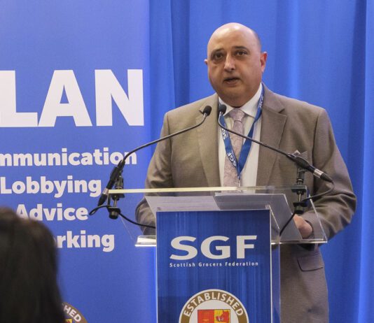 SGF highlights the true cost of wage hikes to business Pete Cheema, chief executive at the SGF, stands at a podium.