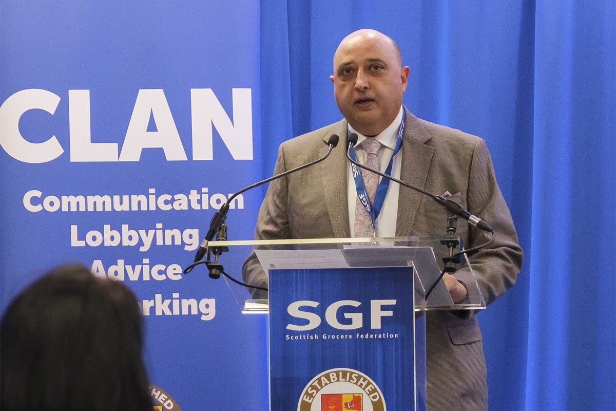 Pete Cheema, chief executive at the SGF, stands at a podium.