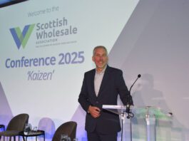 Scottish Wholesale Association puts sector resilience centre stage Colin Smith, chief executive at the Scottish Wholesale Association, stands at a lectern on a stage at the SWA 2025 Annual Conference.