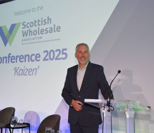 Scottish Wholesale Association puts sector resilience centre stage Colin Smith, chief executive at the Scottish Wholesale Association, stands at a lectern on a stage at the SWA 2025 Annual Conference.