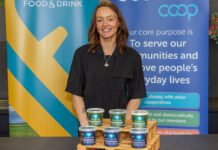 Yester Farm Dairies rolls out in Scotmid stores A woman stands behind a table with pots of Yester Farm Dairies Cottage Cheese on it.
