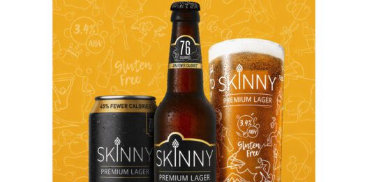 Global Brands acquires Skinny Brands low-calorie beer A can, a bottle and a pint glass of Skinny Brands lager stand against a yellow background.