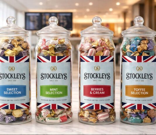 Stockleys broadens gifting options with Heritage Jars Stockleys Heritage Jars stand in a line against a tourist-themed background.