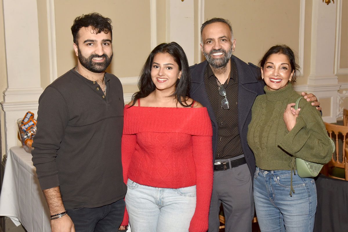 The Sud family stands together for an image.