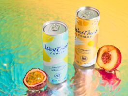 West Coast Coolers land across Scottish shelves Cans of West Coast Cooler Original and West Coast Cooler Sunburst stand on a watery surface with a passionfruit and peach standing next to them.