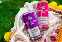 Whitley Neill enters into RTD market Cans of Whitley Neill Rhubarb & Ginger with Ginger Ale and Yuzu & White Strawberry with Lemonade sit in a wicker basket on grass with lemons around the basket.