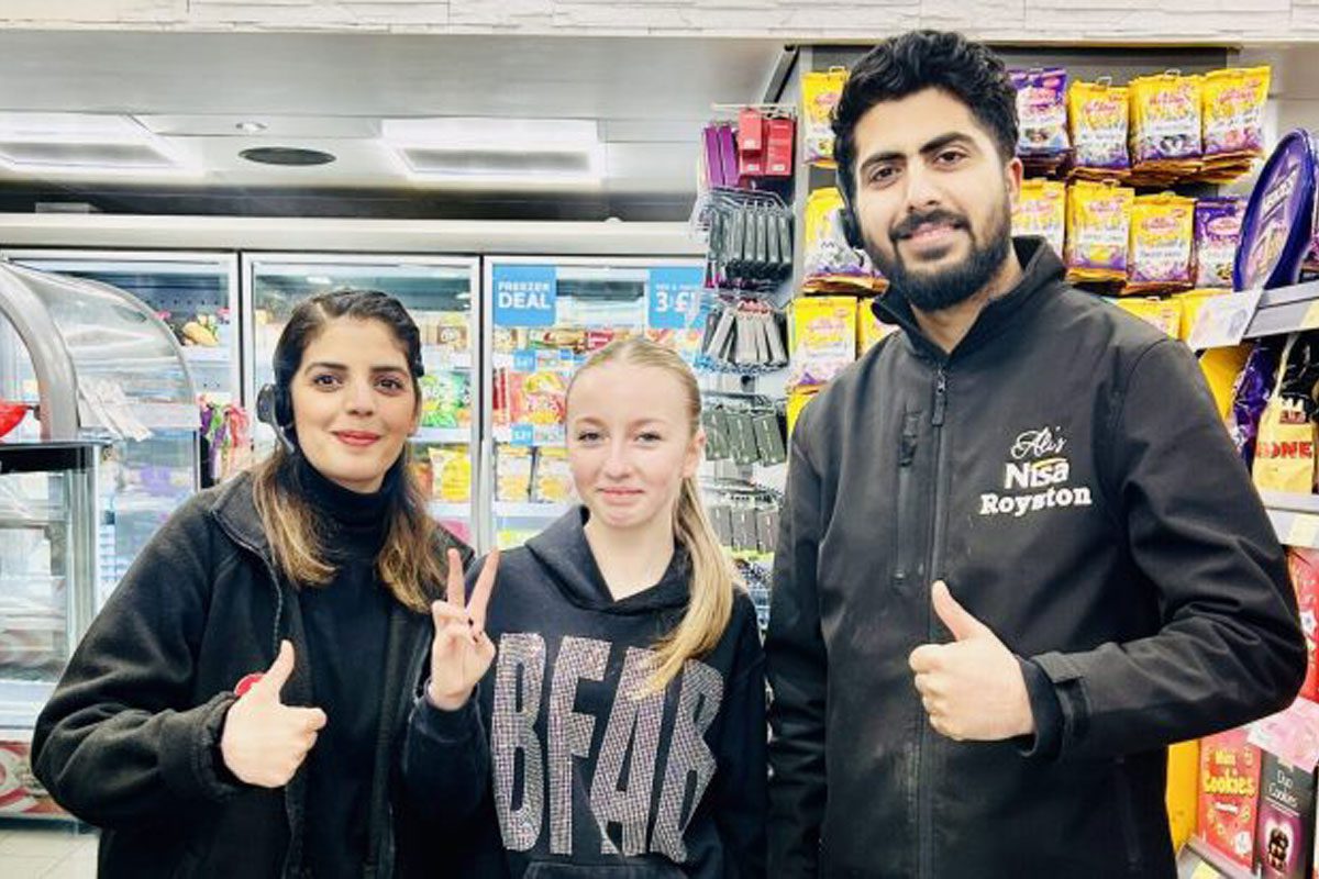 Staff members from Ali's Nisa in Royston stand with Mirren King.