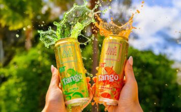 Au Vodka teams up with Tango on new cocktail cans A person holds up two cans of Au Vodka Tango one in Apple and one in Orange with the drinks spilling out the top of the cans.