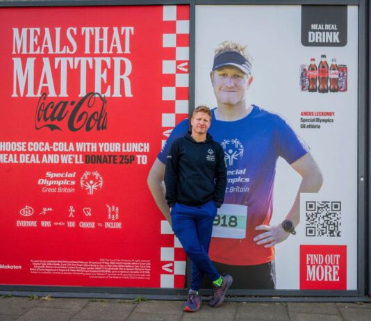 CCEP supports Special Olympics with Meals that Matter Angus Leckonby, Special Olympics GB Athlete, stands in front of the CCEP Meals that Matter promotional image which features him.