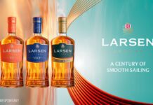 Larsen Cognac unveils new premium bottle design Promotional image of the Larsen Cognac redesign for 2026 featuring the new bottles next to the company logo with text that reads "A Century of Smooth Sailing".