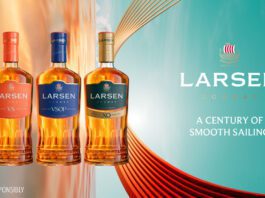 Larsen Cognac unveils new premium bottle design Promotional image of the Larsen Cognac redesign for 2026 featuring the new bottles next to the company logo with text that reads "A Century of Smooth Sailing".