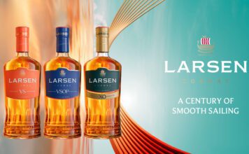 Larsen Cognac unveils new premium bottle design Promotional image of the Larsen Cognac redesign for 2026 featuring the new bottles next to the company logo with text that reads "A Century of Smooth Sailing".