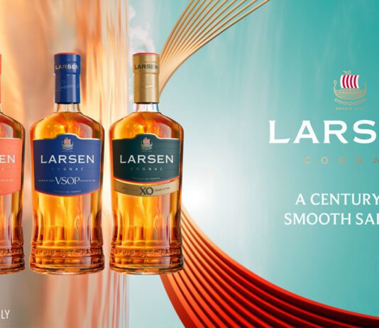 Larsen Cognac unveils new premium bottle design Promotional image of the Larsen Cognac redesign for 2026 featuring the new bottles next to the company logo with text that reads "A Century of Smooth Sailing".