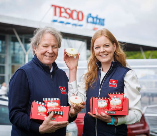 McGhee’s Empire Biscuit joins Tesco meal deal range Gordon McGhee and Aisling McGhee stand outside a Tesco supermarket store holding empire biscuits.