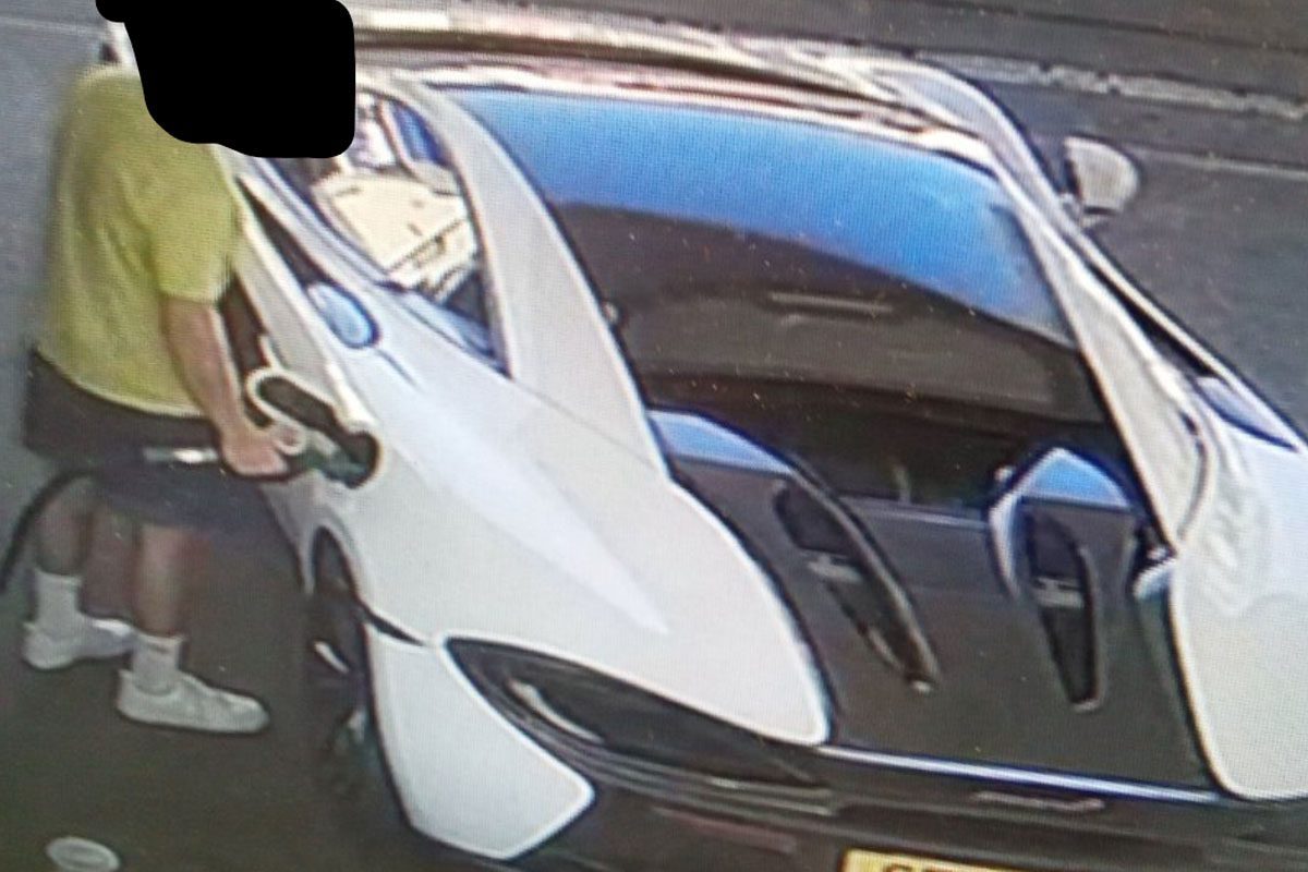 A driver fills up fuel on his Mclaren.