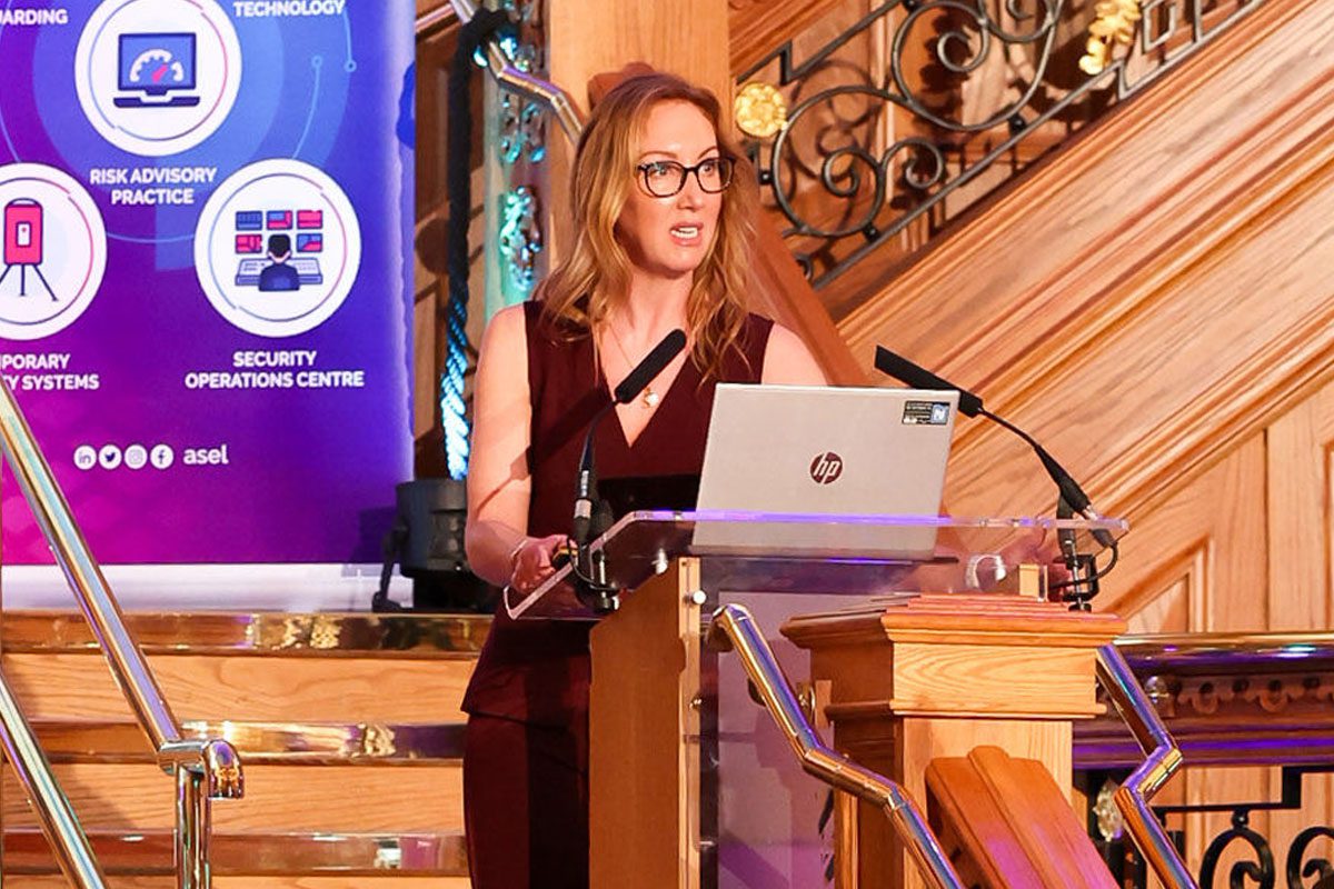Stephanie Karté, chief executive at Retailers Against Crime, stands at a podium during the RAC Conference in Belfast.