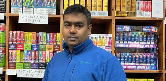 The Fed calls on ScotGov to put retailers at the heart of agenda Uthayakumar Soundararajan, Scottish president at The Federation of Independent Retailers, stands inside a store with licensed products behind him.
