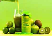 Vault City dials up sour tastes with Marvellous Liquids range A can of Vault City Splendiferous Slime stands amongst green fruit with green slime on top of the can whilst the beer is poured out into a Vault City glass behind the can.
