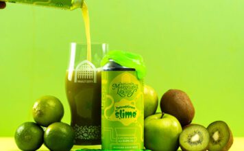 Vault City dials up sour tastes with Marvellous Liquids range A can of Vault City Splendiferous Slime stands amongst green fruit with green slime on top of the can whilst the beer is poured out into a Vault City glass behind the can.
