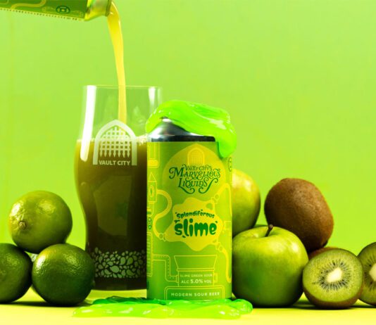 Vault City dials up sour tastes with Marvellous Liquids range A can of Vault City Splendiferous Slime stands amongst green fruit with green slime on top of the can whilst the beer is poured out into a Vault City glass behind the can.
